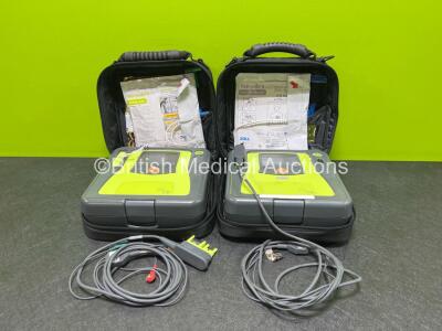 2 x Zoll AED PRO Defibrillators with 2 x LiMnO2 Batteries (1 x Flat Battery) 2 x ECG Leads and 2 x Electrode Pads *Both in Date* in Carry Cases (Both Power Up) *SN AA14L034720 / AA14J033891*