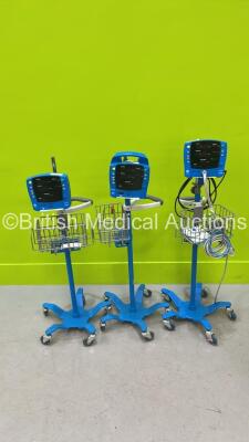 2 x GE Carescape V100 Vital Signs Monitors on Stands and 1 x GE Dinamap ProCare Auscultatory Vital Signs Monitor on Stand (All Power Up) *S/N 2008354 / SDT08360320SP / SDT10480511SA*