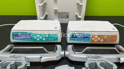 2 x B.Braun Infusomat Space Infusion Pumps (Both Power Up) with 2 x Power Supplies, 2 x B.Braun Space Stations (1 x Damaged / Missing Casing - See Photos) and 2 x Pole Clamps - 3