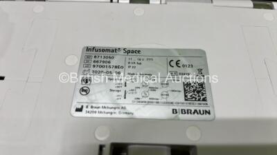 2 x B.Braun Infusomat Space Infusion Pumps (Both Power Up) with 2 x Power Supplies, 2 x B.Braun Space Stations (1 x Damaged / Missing Casing - See Photos) and 2 x Pole Clamps - 10