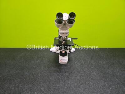 Leica DMLS Type 020-518.500 DM / LS Bench Microscope (Powers Up) 2 x HC plan 10x Eyepieces and 5 x Optics Including 1 x NPLAN 40x/0.65, 1 x 2.5x, 1 x NPLAN 5x/0.12, 1 x NPLAN 10x/0.20 and 1 x 20x