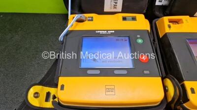 2 x Medtronic Lifepak 1000 Defibrillators *Mfd - 2018 / 2014* (Both Power Up) in Case with 2 x 3 Lead ECG Leads and 2 x Li/MnO2 Batteries *Install Before - 2024 / 2024* - 2