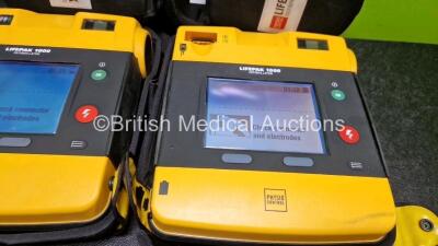 2 x Medtronic Lifepak 1000 Defibrillators *Mfd - 2018 / 2014* (Both Power Up) in Case with 2 x 3 Lead ECG Leads and 2 x Li/MnO2 Batteries *Install Before - 2024 / 2024* - 3