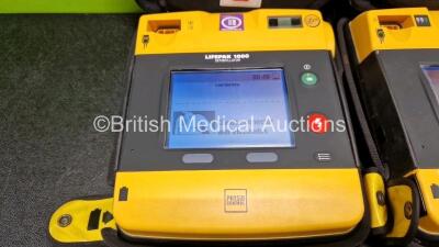 2 x Medtronic Lifepak 1000 Defibrillators *Mfd - 2016 / 2007* (Both Power Up) in Case with 2 x 3 Lead ECG Leads and 2 x Li/MnO2 Batteries *Install Before - 2027 / 2023* - 2