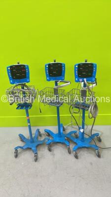 3 x GE Carescape V100 Vital Signs Monitors on Stands with 1 x Power Supply (All Power Up)