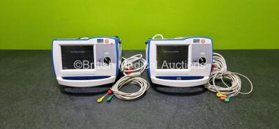 2 x Zoll R Series Plus Defibrillators / Monitors (Both Power Up) Including ECG and Printer Options with 2 x 3 Lead ECG Leads, 2 x Paddle Leads, 2 x Power Cords and 2 x Lithium Ion Rechargeable Batteries *SN AF13B027392 / AF13B027385*