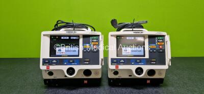 Job Lot Including 2 x Physio Control Lifepak 20e Defibrillator / Monitors (Both Power Up and 1 x Cracked Case - See Photos) Including ECG and Printer Options with 2 x Li-ion Batteries, 2 x Paddle Leads and 2 x 3 Lead ECG Leads and 2 x Code Management Modu