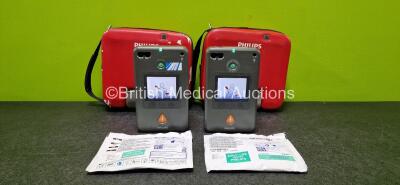 2 x Philips Heartstart FR3 Defibrillator (Both Power Up and 1 x Foreign Voice) in 2 x Carry Cases with 2 x LiMnO2 Batteries *Install Before - 2025 & 2026* and 2 x Electrodes *1 x Expired*