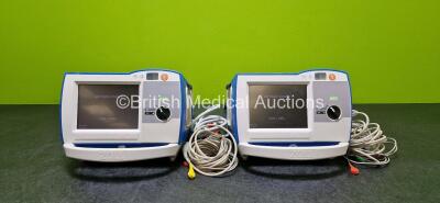 2 x Zoll R Series Plus Defibrillators / Monitors (Both Power Up) Including ECG and Printer Options with 2 x 3 Lead ECG Leads, 2 x Paddle Leads, 2 x Power Cords and 2 x Lithium Ion Rechargeable Batteries *SN AF13B027387 / AF12F023122*