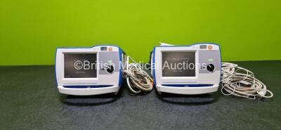 2 x Zoll R Series Plus Defibrillators / Monitors (Both Power Up) Including ECG and Printer Options with 2 x 3 Lead ECG Leads (Both Damaged Casings - See Photos), 2 x Paddle Leads, 2 x Power Cords and 2 x Lithium Ion Rechargeable Batteries *SN AF13B027395