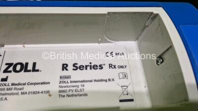 2 x Zoll R Series Plus Defibrillators / Monitors (Both Power Up) Including ECG and Printer Options with 2 x 3 Lead ECG Leads (Both Damaged Casings - See Photos), 2 x Paddle Leads, 2 x Power Cords and 2 x Lithium Ion Rechargeable Batteries *SN AF13B027395 - 13