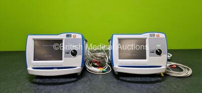 2 x Zoll R Series Plus Defibrillators / Monitors (Both Power Up) Including ECG and Printer Options with 2 x 3 Lead ECG Leads (Both Damaged Casings - See Photos), 2 x Paddle Leads, 2 x Power Cords and 2 x Lithium Ion Rechargeable Batteries *SN AF13B027383