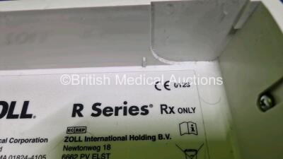 2 x Zoll R Series Plus Defibrillators / Monitors (Both Power Up) Including ECG and Printer Options with 2 x 3 Lead ECG Leads (Both Damaged Casings - See Photos), 2 x Paddle Leads, 2 x Power Cords and 2 x Lithium Ion Rechargeable Batteries *SN AF13B027383 - 14