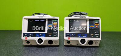 2 x Physio Control Lifepak 20e Defibrillators / Monitors (Both Power Up and Both Damaged Casings - See Photos) Including Pacer, ECG and Printer Options with 2 x Li-ion Batteries and 2 x Paddle Leads *SN 39387925 / 38384516*