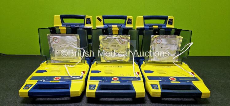 6 x Cardiac Science Powerheart AED G3 Automated External Defibrillators (All Power Up, 1 x Damaged Connector and 1 x Faulty Screen - See Photos) with 2 x LiSO2 Batteries and 5 x Electrodes *4 x Expired - 1 x Expiry Date 2025* *SN 4355000 / 4004321 / 36919