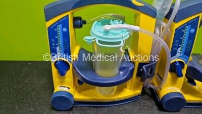 2 x Laerdal LSU Suction Units (Both Power Up , 1 x with Crack in Casing - See Photo) with 2 x Suction Cups (1 x Missing Lid) - 2