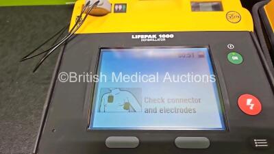 2 x Medtronic Lifepak 1000 Defibrillators (Both Power Up) with 2 x Li/Mno2 Batteries *Install Before - 2024 / 2024* - 2