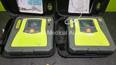 2 x Zoll AEDPro Defibrillators (Both Power Up Both with Damage to Screen - See Photo) in Case with 2 x 3 Lead ECG Leads and 2 x Li-ion Batteries - 2