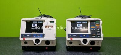 Job Lot Including 2 x Physio Control Lifepak 20e Defibrillators / Monitors (Both Power Up and 1 x Missing Casing - See Photo) Including Pacer, ECG and Printer Options with 2 x Li-ion Batteries, 2 x Paddle Leads and 2 x 3 Lead ECG Leads and 2 x Code Manage