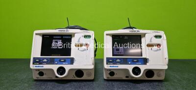 Job Lot Including 2 x Medtronic Lifepak 20e Defibrillators / Monitors (Both Power Up and 1 x Damaged Casing - See Photo) Including Pacer, ECG and Printer Options with 2 x Li-ion Batteries, 2 x Paddle Leads and 2 x 3 Lead ECG Leads *SN 35995801 / 37380672*