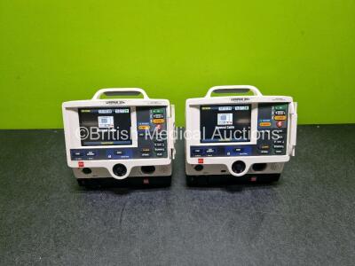 2 x Physio Control Lifepak 20e Defibrillators / Monitors (Both Power Up Both with Cracks in Casing - See Photos ) Including Pacer, ECG and Printer Options with 2 x Li-ion Batteries and 2 x Code Management Modules Including CO2 Options