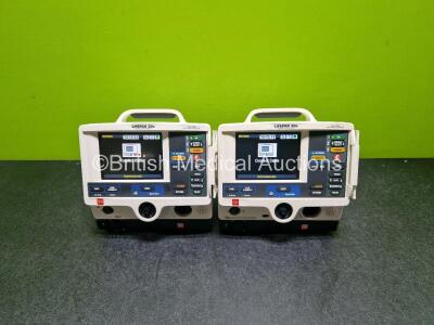 2 x Physio Control Lifepak 20e Defibrillators / Monitors (Both Power Up Both 1 x with Crack in Casing - See Photos ) Including Pacer, ECG and Printer Options with 2 x Li-ion Batteries and 2 x Code Management Modules Including CO2 Options