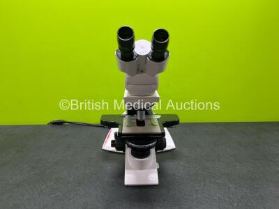 Leica DM2000 Benchtop Microscope with 2 x HC Plan 10x/22 Eyepieces and 4 x Leica Optics *1 x N Plan 20 x /0.40, 1 x N Plan 10 x 0.25, 1 x C Plan 4 x /0.10, 1 x N Plan 100 x /1.25-0.60*