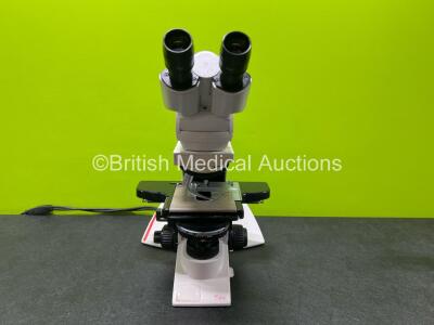 Leica DM2000 Benchtop Microscope with 2 x HC Plan 10x/22 Eyepieces and 3 x Leica Optics *1 x C Plan 4 x /0.10, 1 x N Plan 100 x /1.25-0.60, 1 x N Plan 10 x /0.25*