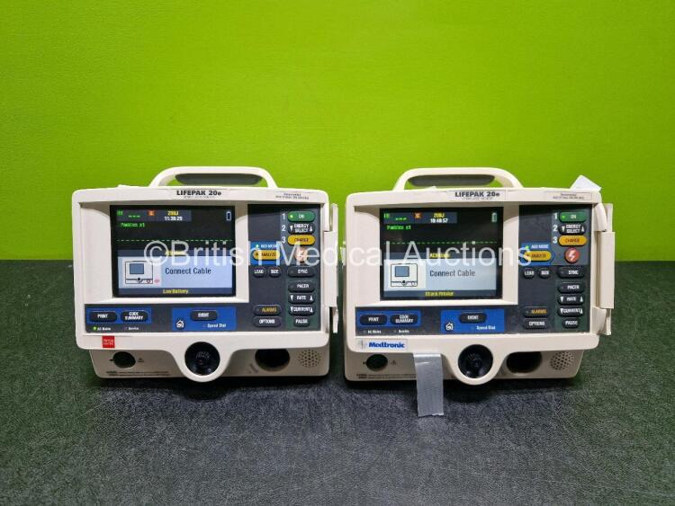 2 x Physio Control Lifepak 20e Defibrillators / Monitors *Mfd - 2013 / 2015 (Both Power Up Both 1 x with Damage - See Photo) Including Pacer, ECG and Printer Options *SN 42310748 / 41178404*