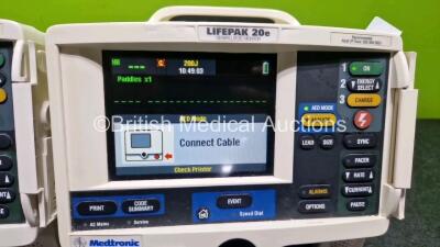 2 x Physio Control Lifepak 20e Defibrillators / Monitors *Mfd - 2013 / 2015 (Both Power Up Both 1 x with Damage - See Photo) Including Pacer, ECG and Printer Options *SN 42310748 / 41178404* - 3