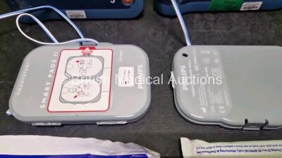 2 x Philips Heartstart FRx Defibrillators (Both Power Up) in Case with 2 x M5070A LiMnO2 Batteries *Install Before 2024 / 2024* and 4 x Smart Pads 2 - 4