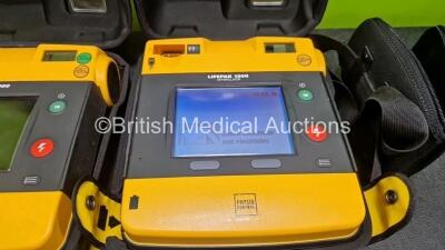 2 x Medtronic Lifepak 1000 Defibrillators (Both Power Up) in Case with 2 x 3 Lead ECG Leads and 1 x Li/Mn02 Battery *SN 42196629 / 42196492* - 2