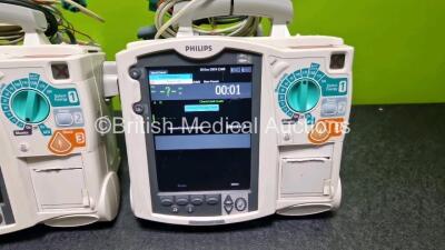 2 x Philips Heartstart MRx Defibrillators (Both Power Up with Stock Module, Stock Module Not Included) Including ECG and Printer Options with 2 x 3 Lead ECG Leads and 2 x Paddle Leads - 3