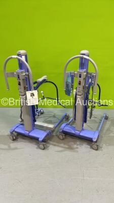 2 x Arjo MaxiMove Electric Patient Hoists with 2 x Batteries and 5 x Controllers (Both Power Up)