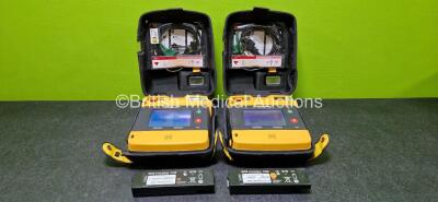 2 x Physio Control Lifepak 1000 Defibrillators (Both Power Up with Stock Battery - Stock Battery Not Included) with 2 x 3 Lead ECG Leads and 2 x Li/MnO2 Batteries *Both Flat* in Carry Cases *SN 42196494 / 62196616*