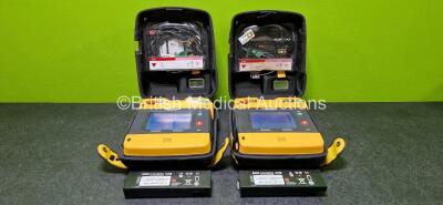 2 x Physio Control Lifepak 1000 Defibrillators (Both Power Up with Stock Battery - Stock Battery Not Included) with 2 x 3 Lead ECG Leads and 2 x Li/MnO2 Batteries *Both Flat* in Carry Cases *SN 42196485 / 42196502*