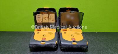 2 x Physio Control Lifepak CR Plus Defibrillators (Both Power Up and 1 x Missing Back Casing - See Photo) with 2 x Lithium Batteries in Cases