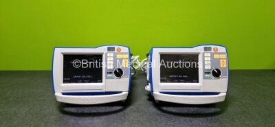 2 x Zoll R Series Plus Defibrillators / Monitors (Both Power Up and Both Missing Batteries - See Photo) Including Pacer, ECG and Printer Options with 2 x Paddle Leads *SN (21)AF15G048264 / (21)AF15B043782*