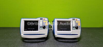 2 x Zoll R Series Plus Defibrillators / Monitors (Both Power Up and Both Missing Batteries - See Photo) Including Pacer, ECG and Printer Options with 2 x Paddle Leads *SN (21)AF15B043765 / (21)AF15B043793*