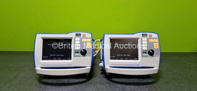 2 x Zoll R Series Plus Defibrillators / Monitors (Both Power Up and Both Missing Batteries - See Photo) Including Pacer, ECG and Printer Options with 2 x Paddle Leads *SN (21)AF15B043788 / (21)AF15F047243*