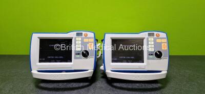 2 x Zoll R Series Plus Defibrillators / Monitors (Both Power Up and Both Missing Batteries - See Photo) Including Pacer, ECG and Printer Options with 2 x Paddle Leads *SN AF13B027349 / AF13B027343*