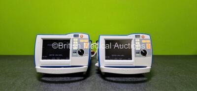 2 x Zoll R Series Plus Defibrillators / Monitors (Both Power Up and Both Missing Batteries - See Photo) Including Pacer, ECG and Printer Options with 2 x Paddle Leads *SN AF13B027346 / AF13B027354*