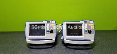 2 x Zoll R Series Plus Defibrillators / Monitors (Both Power Up and Both Missing Batteries - See Photo) Including Pacer, ECG and Printer Options with 2 x Paddle Leads *SN AF13A026801 / AF13B027358*