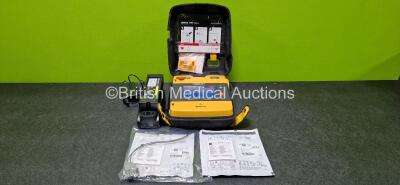 Medtronic Lifepak 1000 Defibrillator (Powers up) with 2 x Li-Ion Batteries and 2 x Electrodes *Both Expired* and 1 x Physio-Control Lifepak 1000 Battery Charger (Powers Up) with 1 x Power Supply