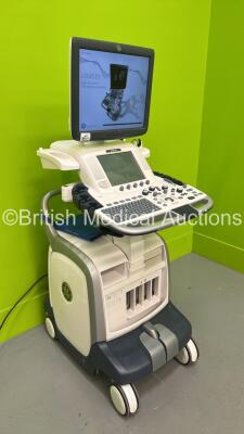 GE Vivid E9 Flat Screen Ultrasound Scanner Model 5205000-4 *S/N 98820US4* **Mfd 2010** Software Version R2.0.4 (Powers Up - Lower Screen Damaged / Missing Rear Lug - See Pictures - Clicking Noise When Turned On ) ***IR223*** - 8