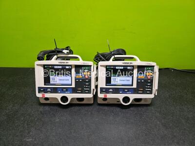 2 x Physio Control Lifepak 20e Defibrillators / Monitors *Mfd - 2020 / 2018* (Both Power Up) Including Pacer ECG and Printer Options with 2 x Paddle Leads, 2 x 3 Lead ECG Leads and 2 x Li-ion Batteries