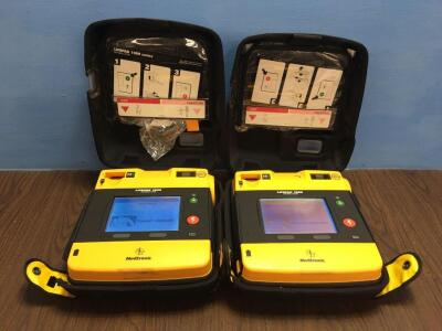 2 x Physio-Control/Medtronic Lifepak 1000 Defibrillators Version 2.51 with Carry Cases,2 x Batteries and 2 x Electrodes (Both Power Up)