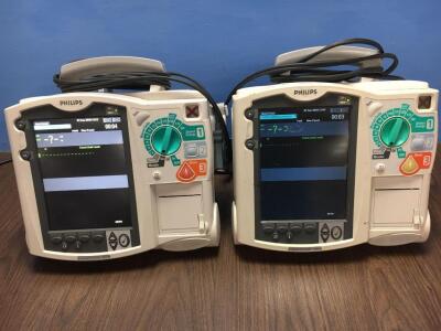 2 x Philips Heartstart MRx Defibrillators Including Pacer, ECG and Printer Options and 2 x Paddle Leads (Both Power Up with Stock Modules off Mains Su