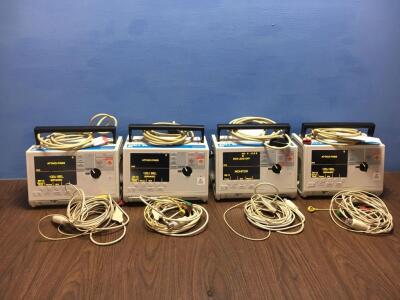 4 x Zoll M Series Defibrillators with 4 x Paddle Leads, 4 x 3 Lead ECG Leads and 4 x Batteries (All Power Up When Plugged in to Mains) *S/N T07I94911