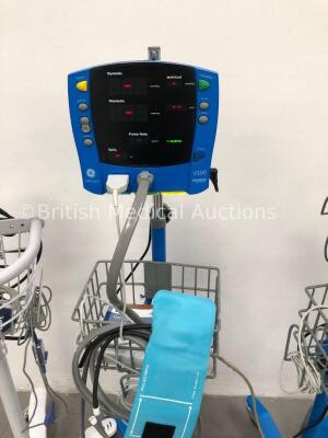 2 x GE Carescape V100 Dinamap Patient Monitors on Stands with 2 x BP Hoses, 2 x BP Cuffs and 2 x SpO2 Finger Sensors and 1 x Welch Allyn 53N00 Patient - 3